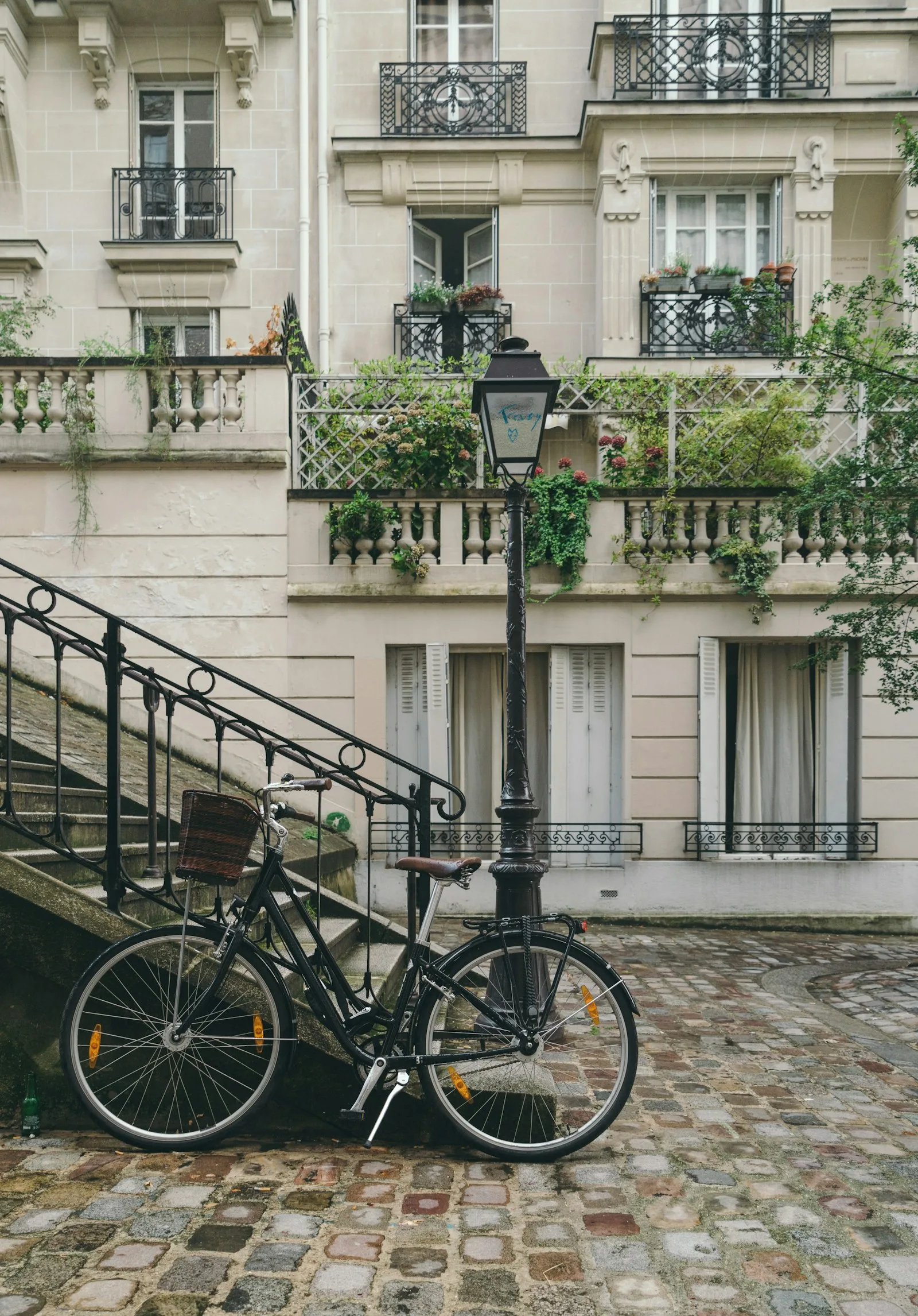 Apartment complex in Paris with a cycle on the pavement