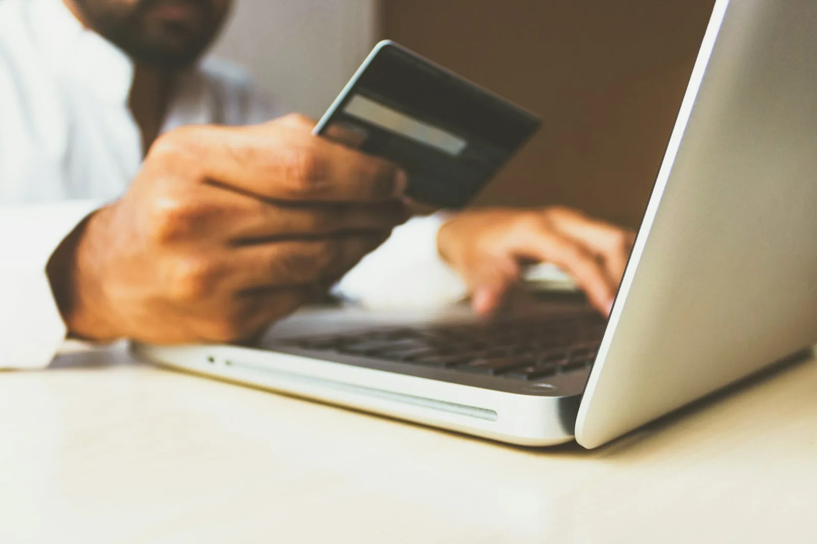 A person holding a credit card and checking his credit score