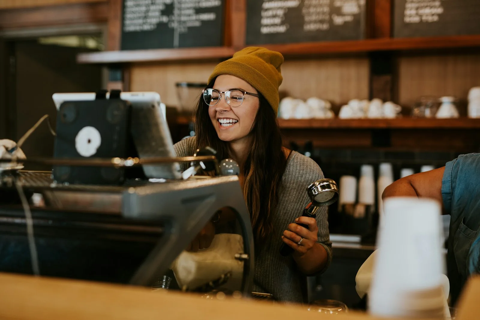A student working at a coffee shop as a part-time job in order to earn extra income