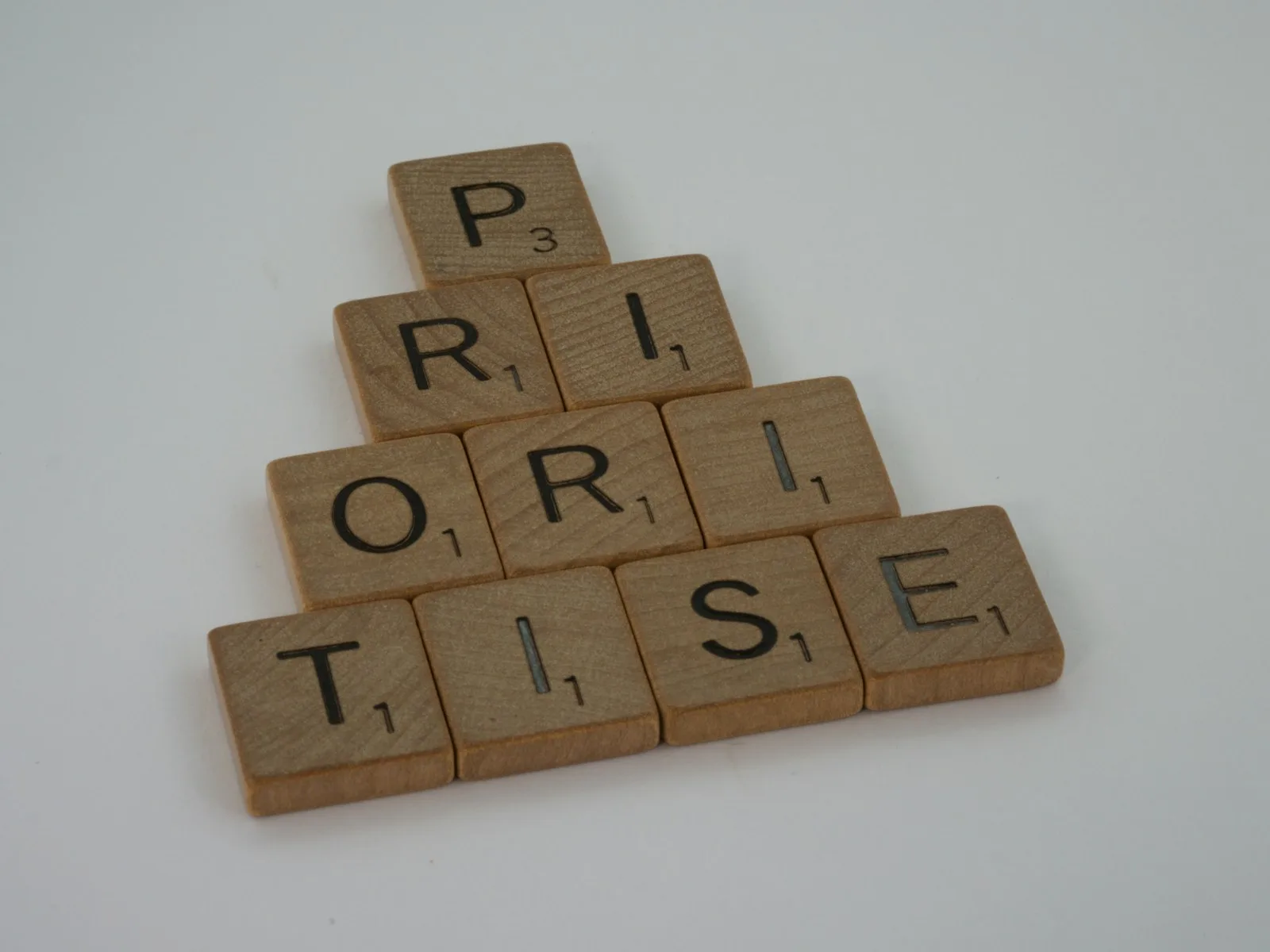 Wooden blocks forming the work “PRIORITISE”