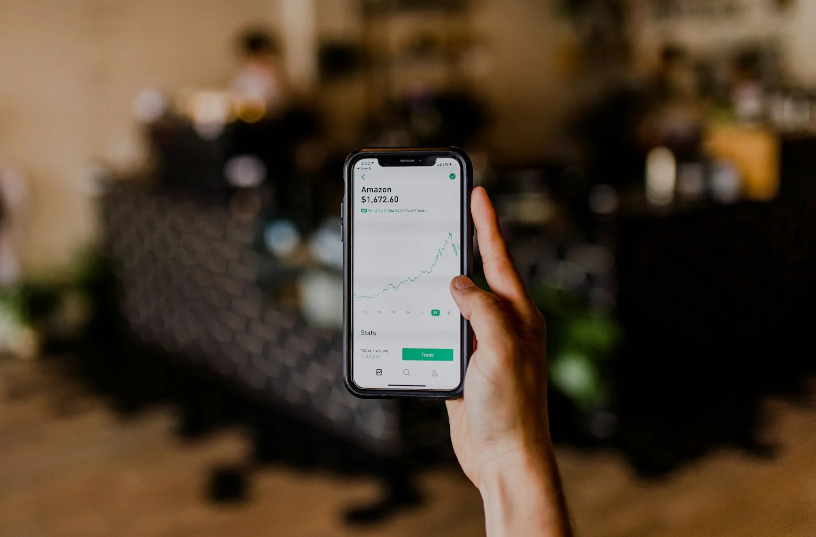 A person checking their growth in portfolio from a mobile application