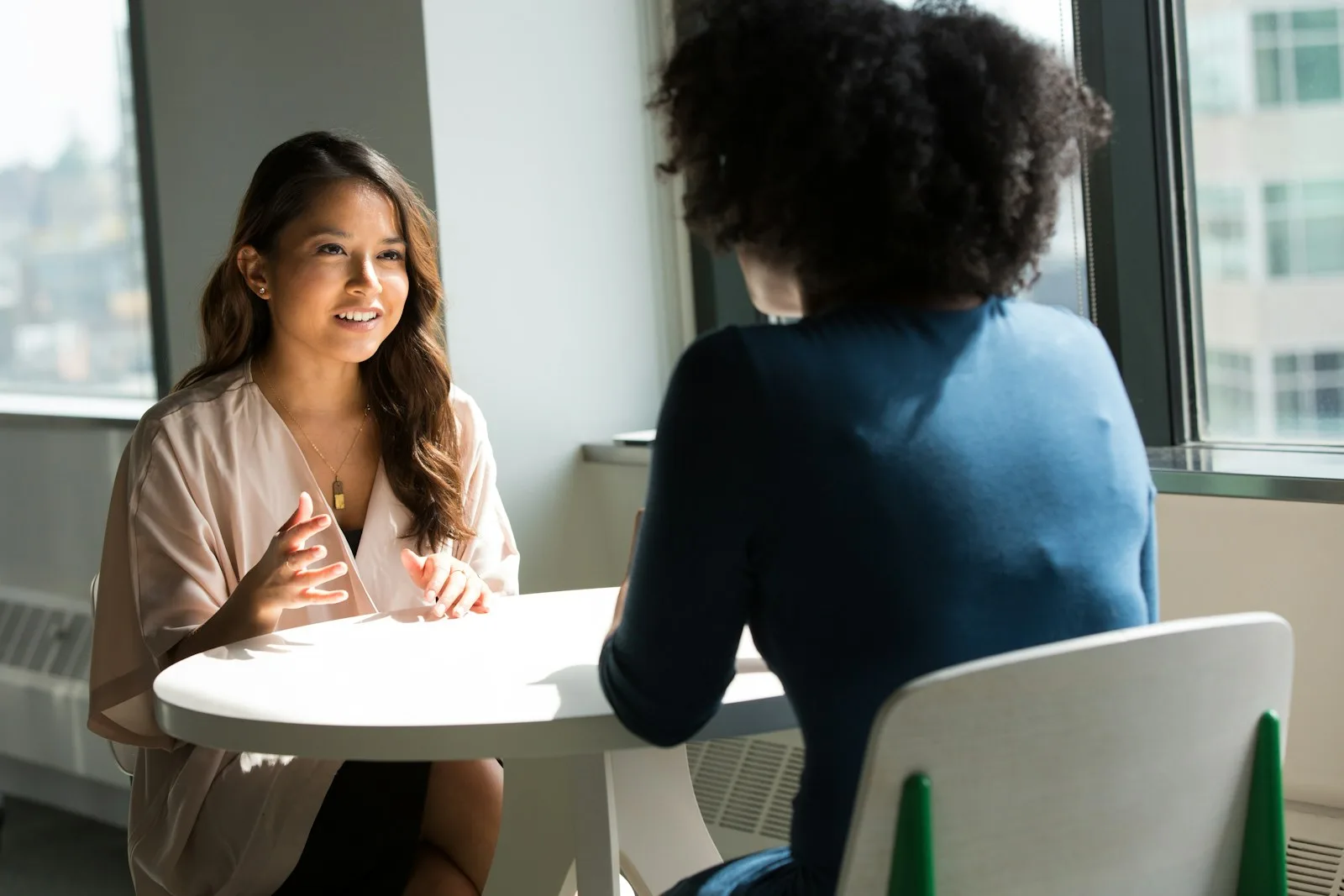 A woman trying to negotiate with a healthcare provider person in order to reduce the medical debt.