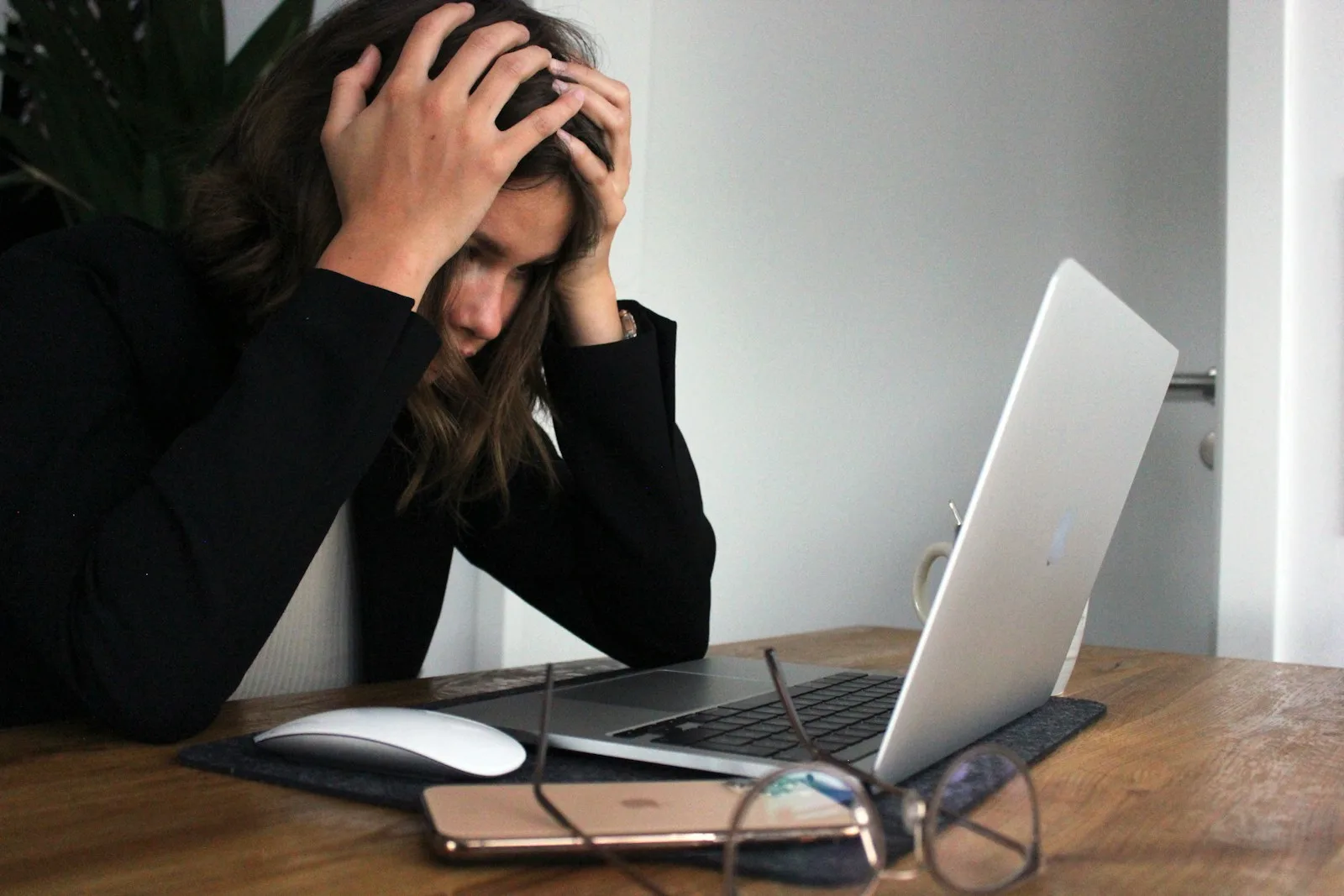Photo of a lady getting stressed looking at all the debt that she has accumulated over time.