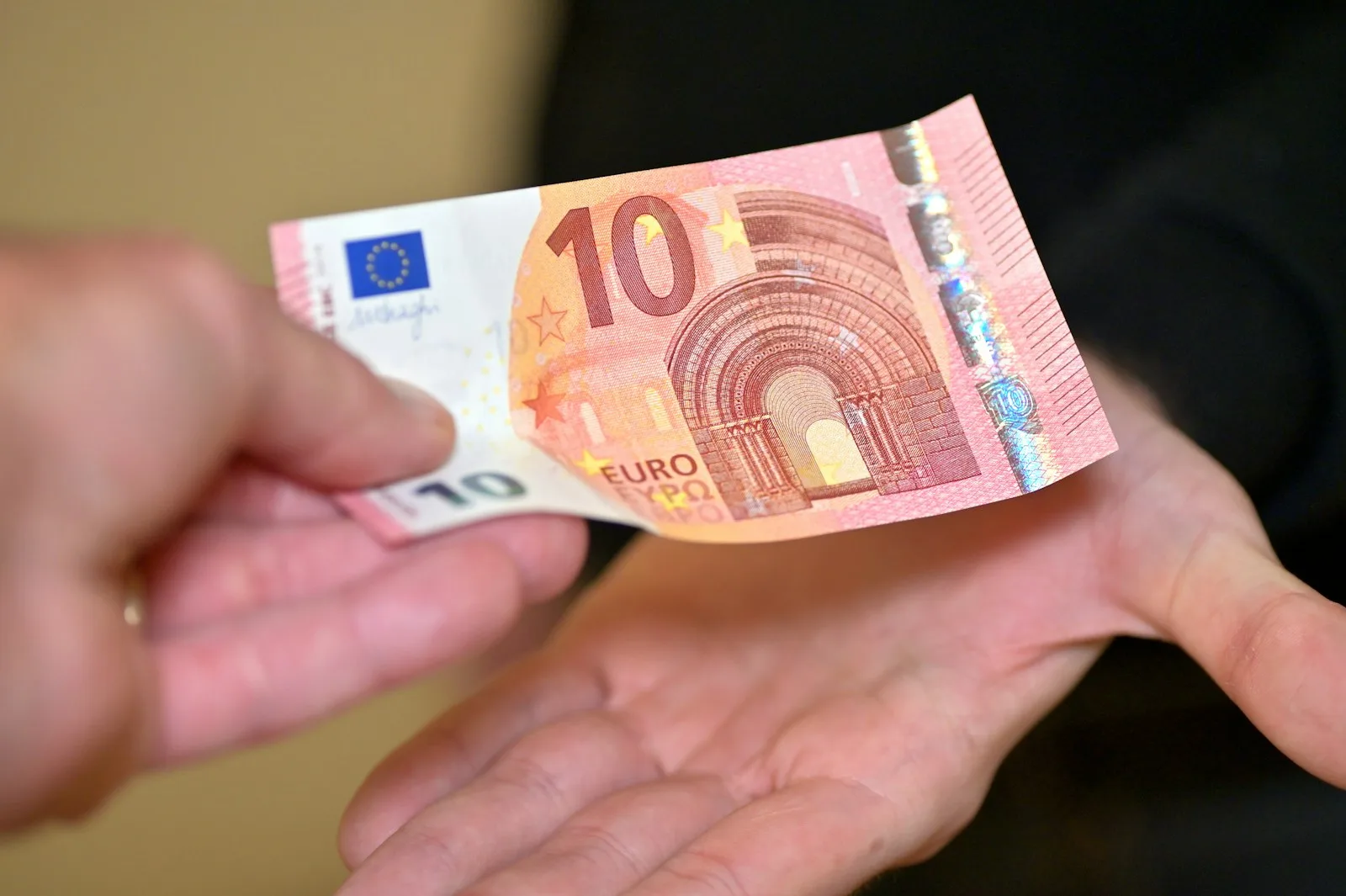 Photo of a person making payment through cash